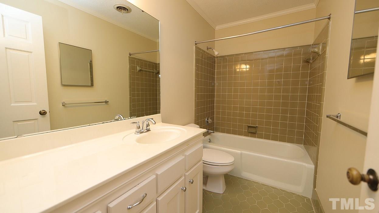 2905 Old Orchard Road Raleigh, NC 27607 - Photo 22 of 27 a bathroom with a bathtub shower sink mirror vanity and toilet