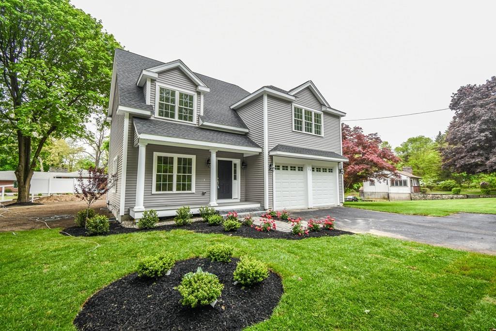 a front view of a house with garden and porch