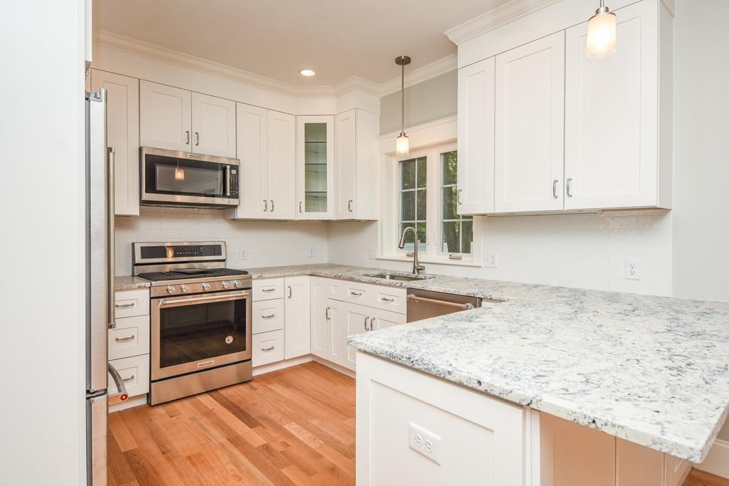 72 Bethany Road Framingham, MA 01702 - Photo 13 of 41 a kitchen with stainless steel appliances granite countertop a stove sink and microwave
