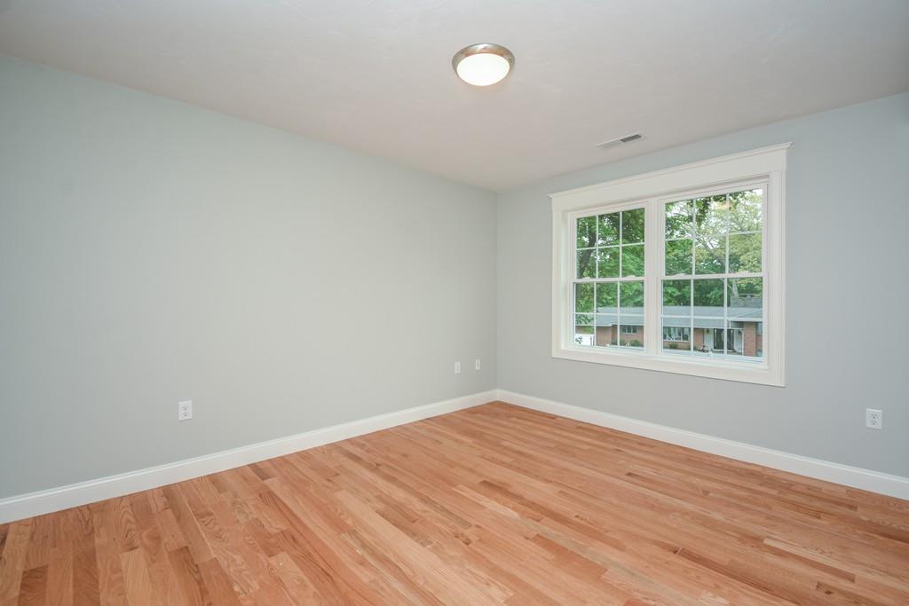 72 Bethany Road Framingham, MA 01702 - Photo 23 of 41 an empty room with wooden floor and windows