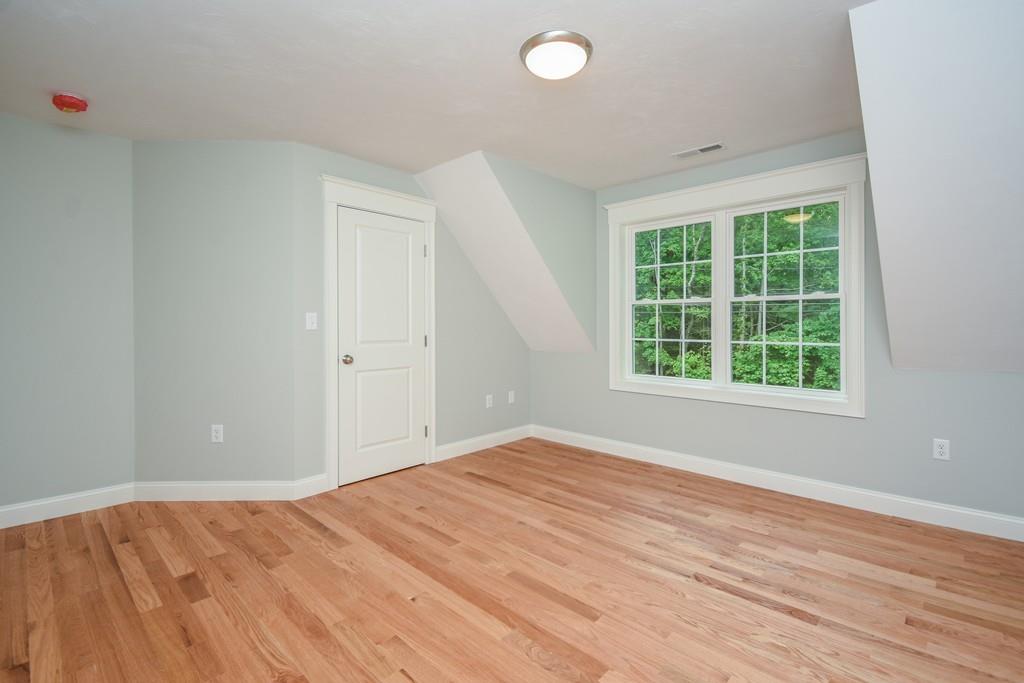 72 Bethany Road Framingham, MA 01702 - Photo 24 of 41 an empty room with wooden floor and windows