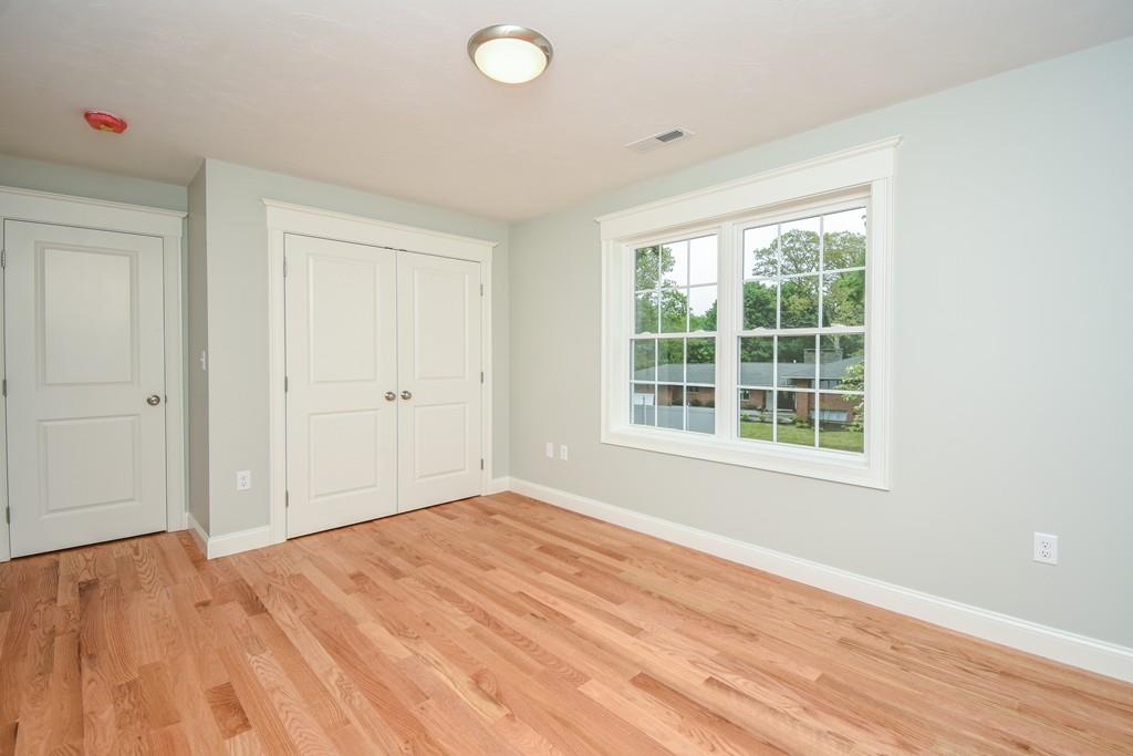 72 Bethany Road Framingham, MA 01702 - Photo 26 of 41 an empty room with wooden floor and windows