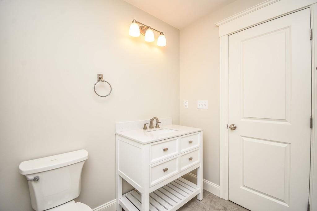 72 Bethany Road Framingham, MA 01702 - Photo 35 of 41 a bathroom with a sink a toilet and a mirror