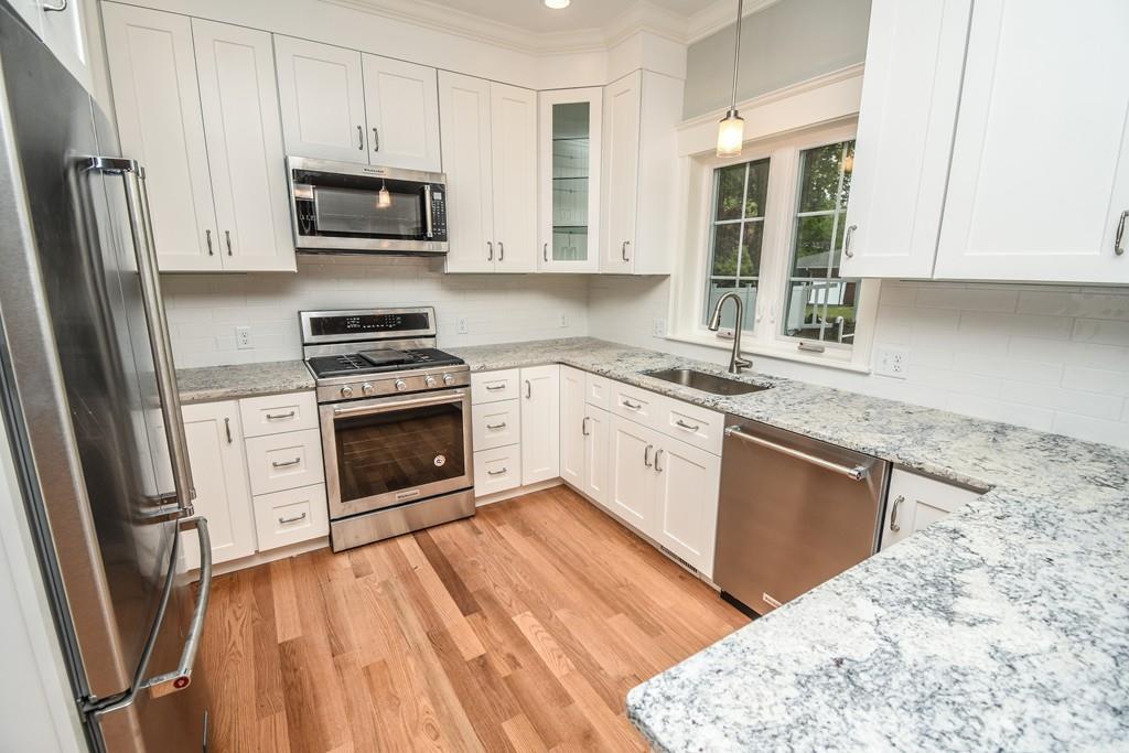 72 Bethany Road Framingham, MA 01702 - Photo 10 of 41 a kitchen with a sink wooden floor and stainless steel appliances