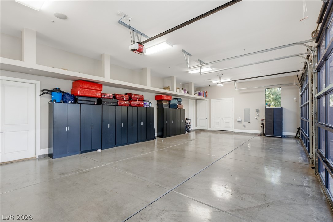 5 Crystal Tree Pass Henderson, NV 89052 - Photo 39 of 67 Ample storage solutions and a pristine concrete floor elevate this functional and organized garage space.