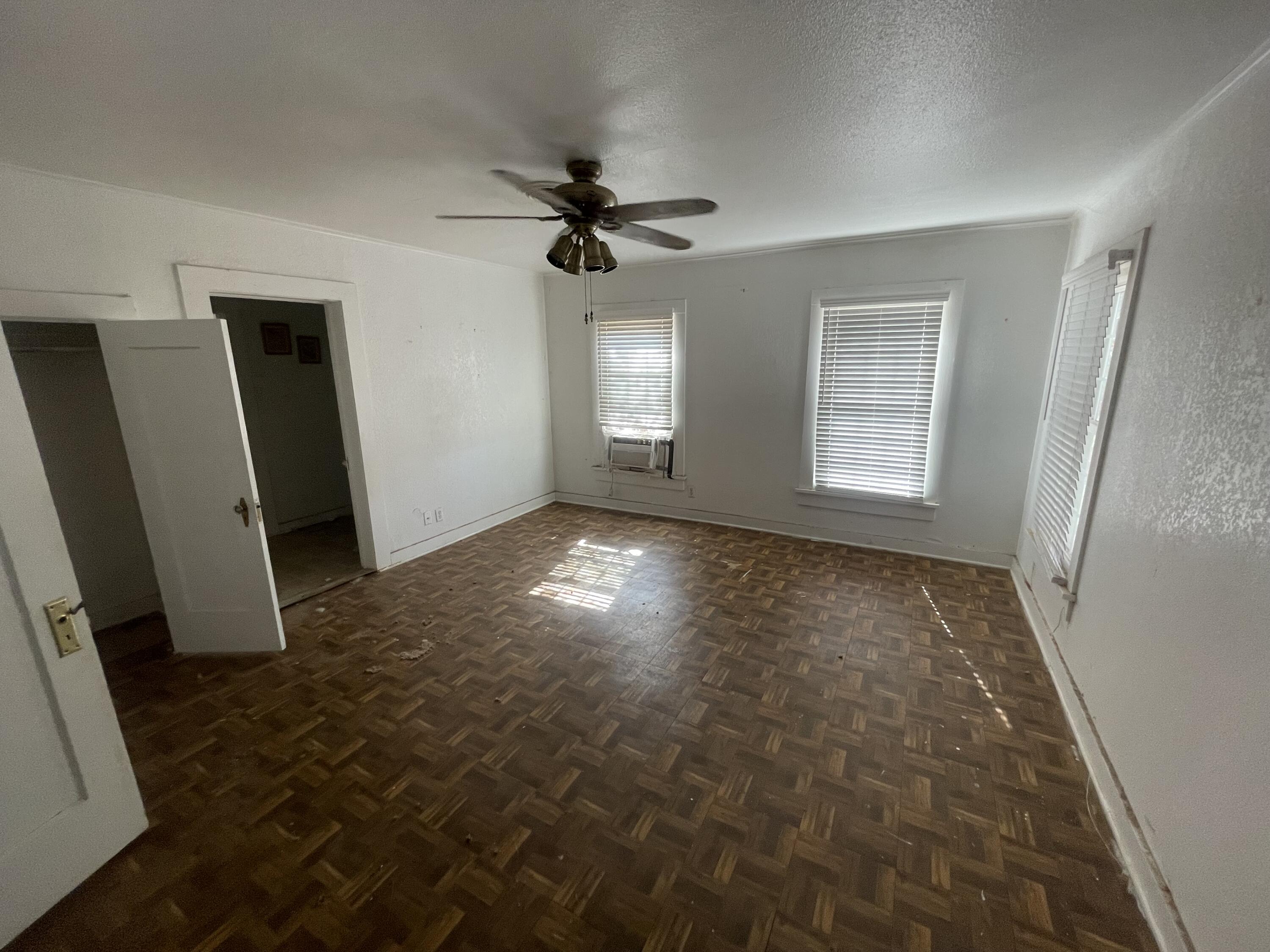 101 S Avenue Post, TX 79356 - Photo 7 of 19 wooden floor in an empty room with a window