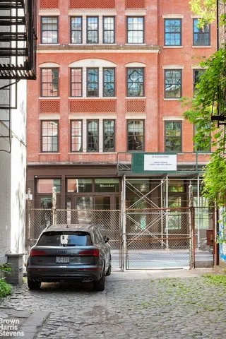 a car parked in front of a brick building
