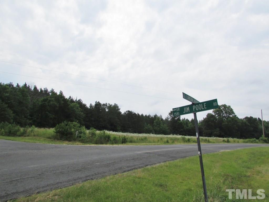 Jim Poole Road Roxboro, NC 27574 - Photo 1 of 11 a view of a road with a big yard and large trees