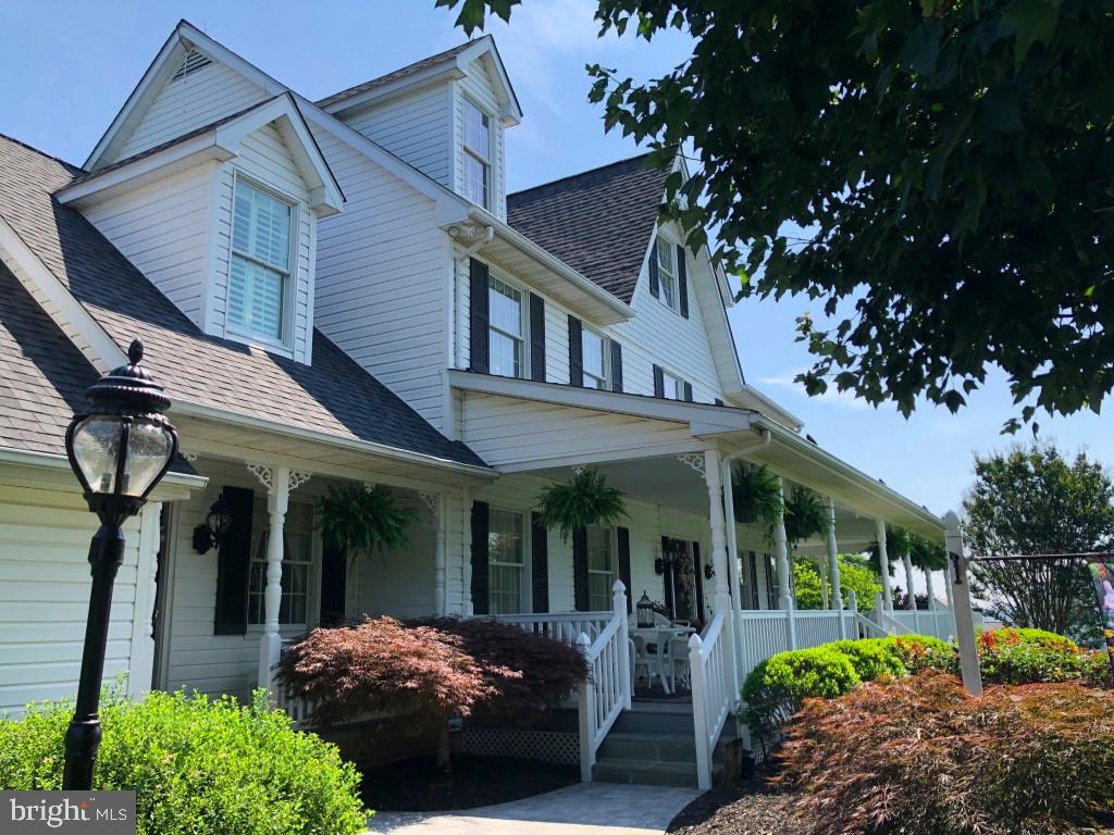 a view of a house with garden and porch