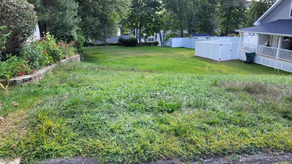 a view of a house with a yard and a house