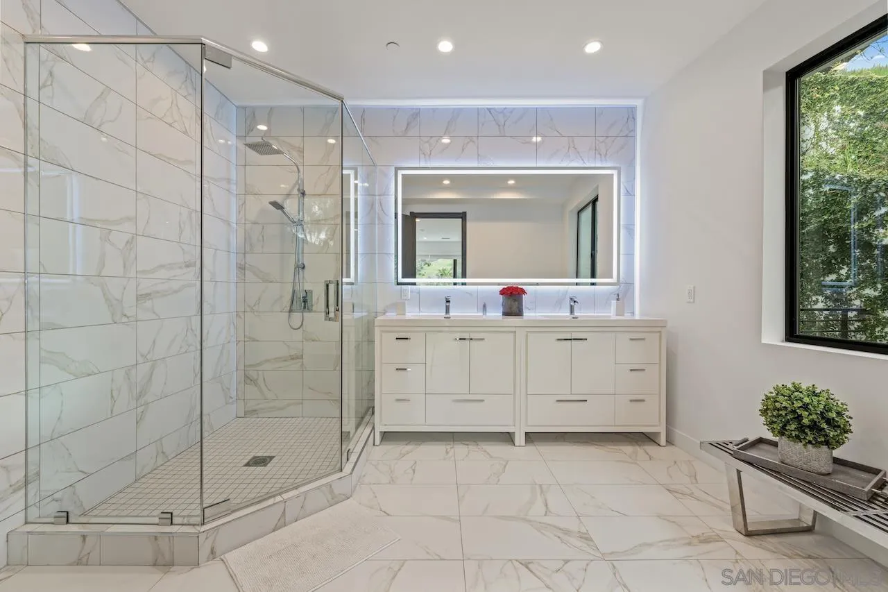 3820 Knobhill Drive Sherman Oaks, CA 91423 - Photo 51 of 75 a bathroom with a shower sink and mirror