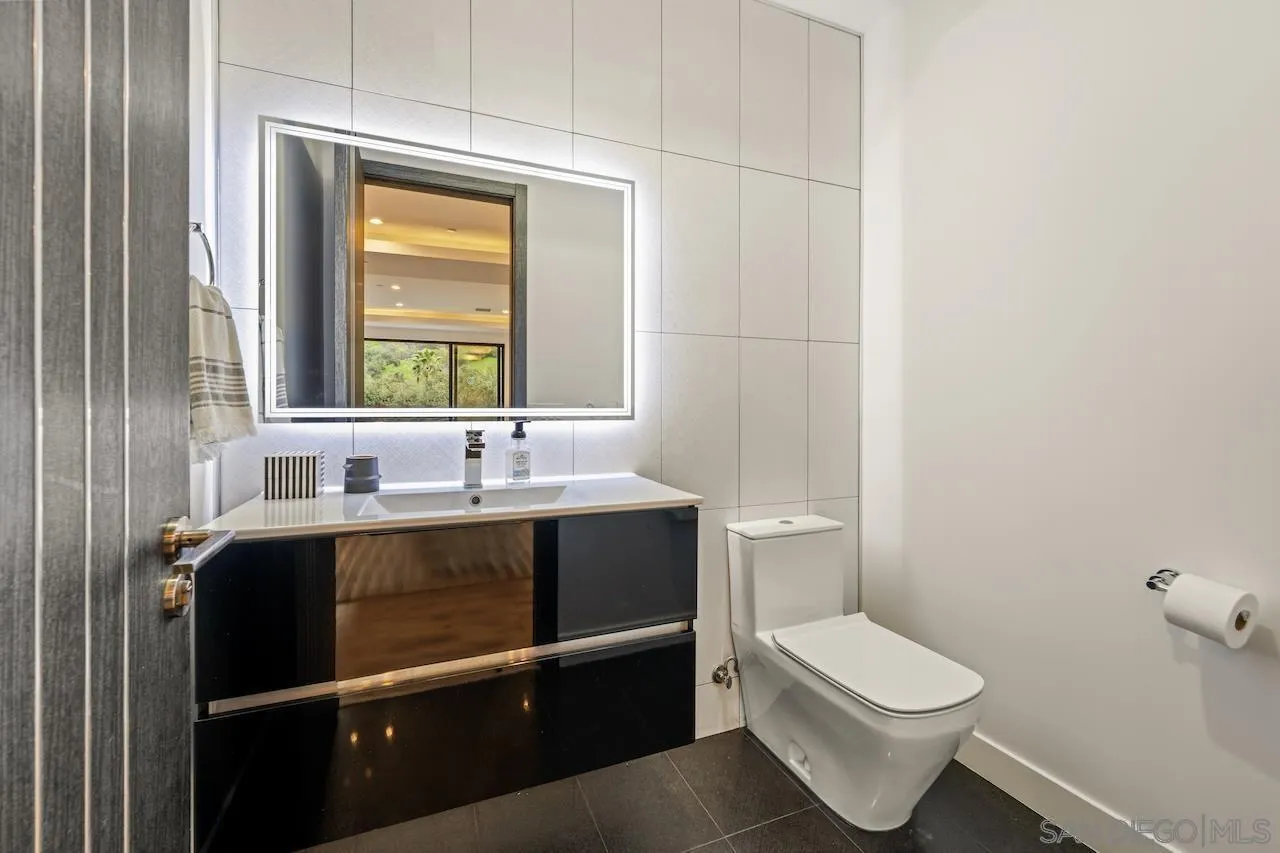 3820 Knobhill Drive Sherman Oaks, CA 91423 - Photo 54 of 75 a bathroom with a toilet sink and mirror