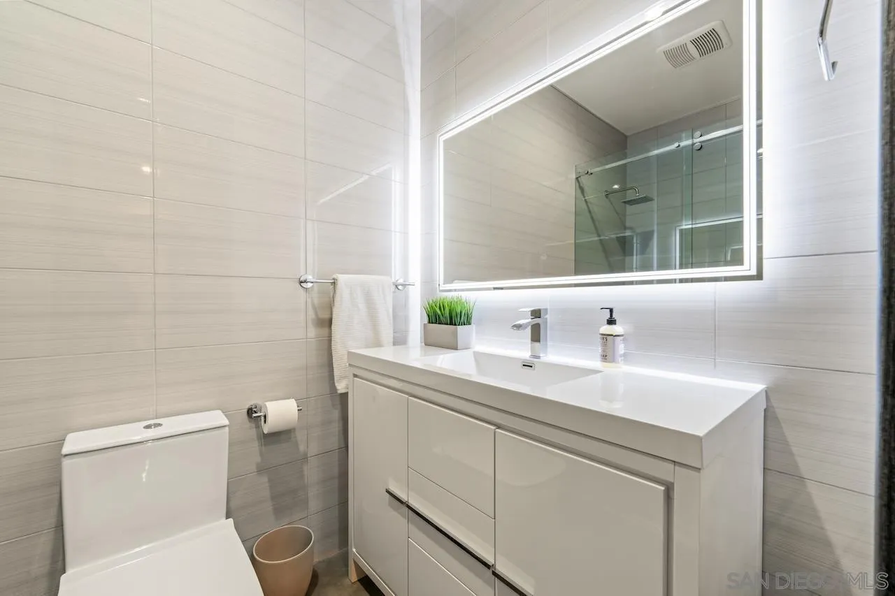 3820 Knobhill Drive Sherman Oaks, CA 91423 - Photo 56 of 75 a bathroom with a toilet sink a mirror and