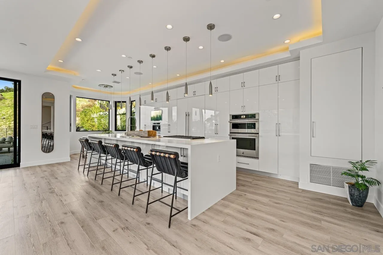 3820 Knobhill Drive Sherman Oaks, CA 91423 - Photo 6 of 75 a kitchen with stainless steel appliances a kitchen island hardwood floor and a sink