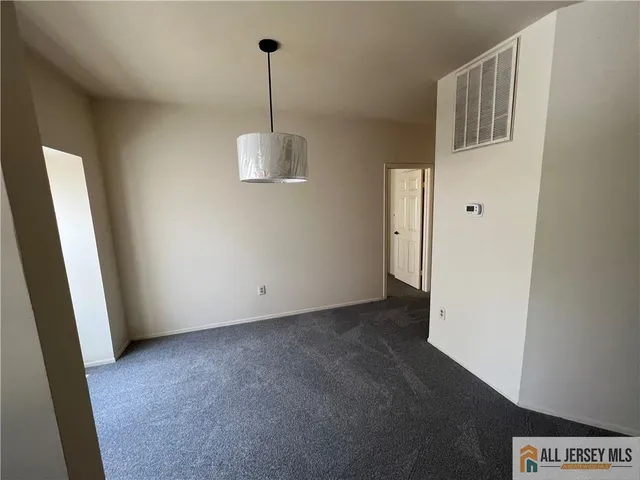 a view of empty room with windows