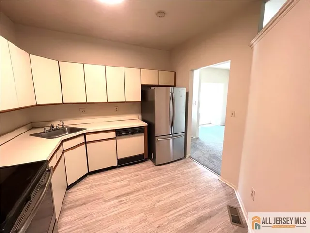 a kitchen with a sink stove and cabinets