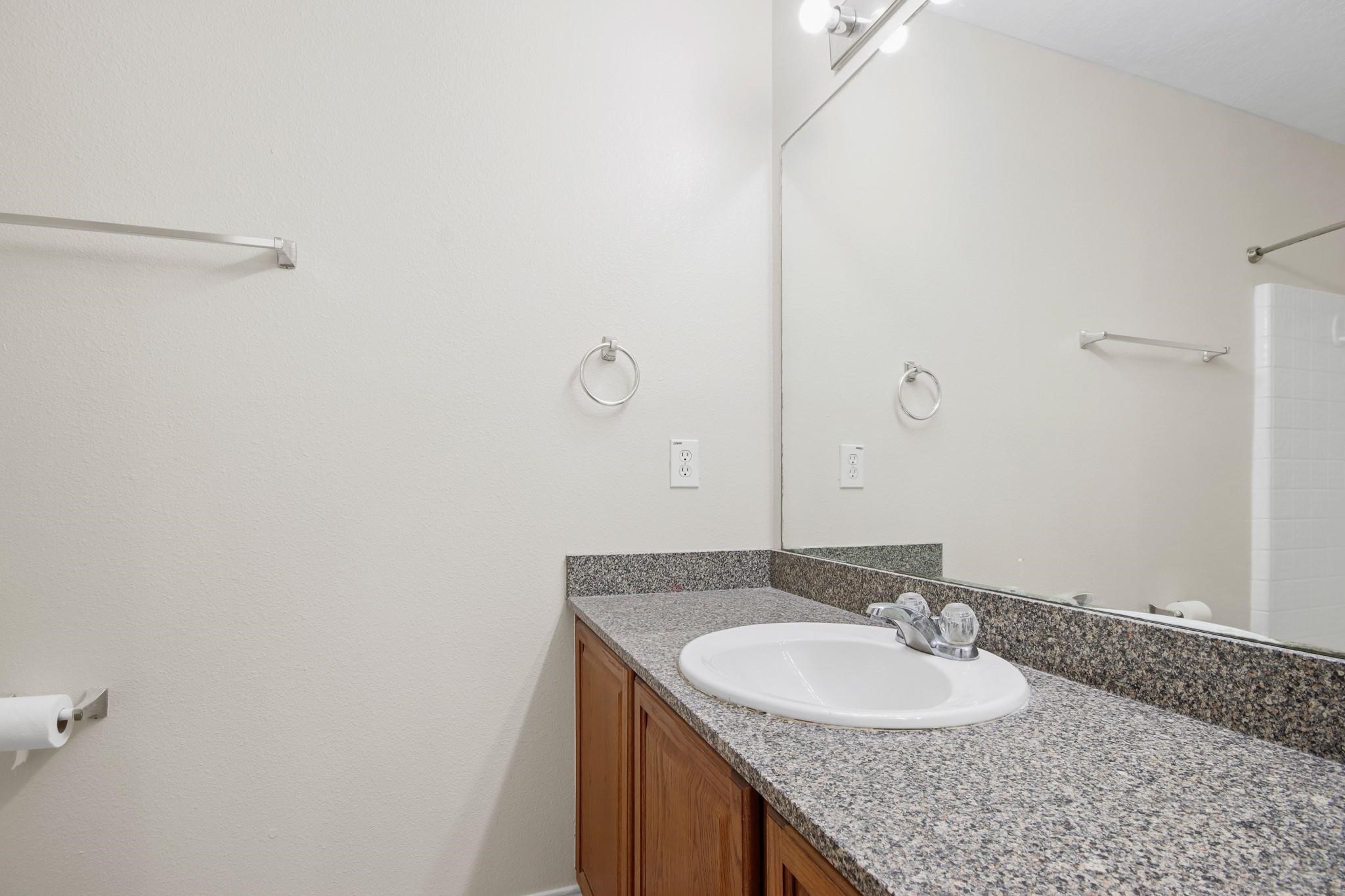 3526 Glenmore Meadow Drive Spring, TX 77386 - Photo 15 of 23 a bathroom with a granite countertop sink and a mirror
