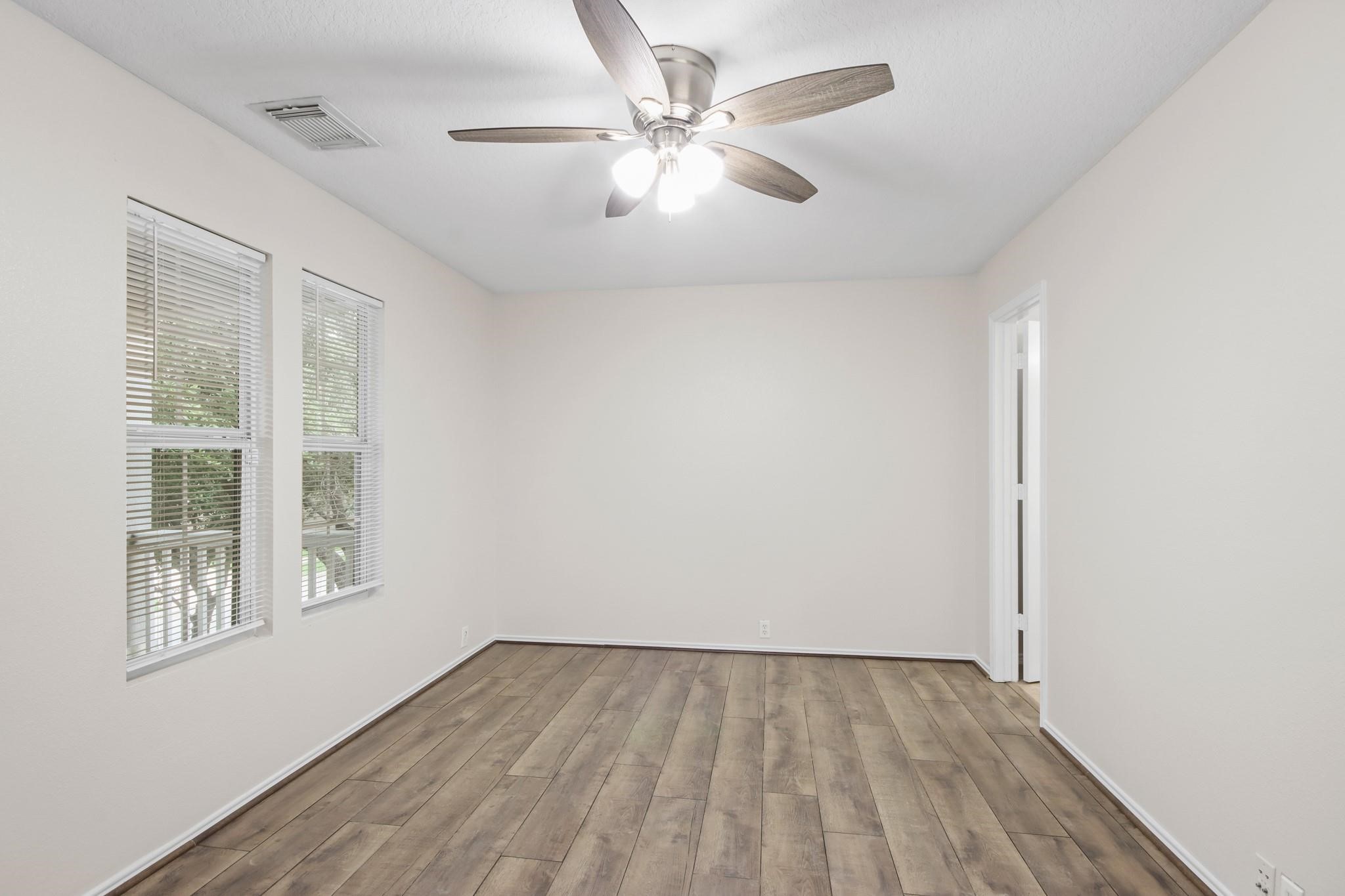 3526 Glenmore Meadow Drive Spring, TX 77386 - Photo 17 of 23 an empty room with a window and a ceiling fan
