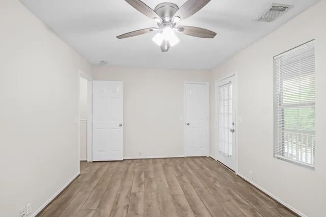wooden floor in an empty room with a window