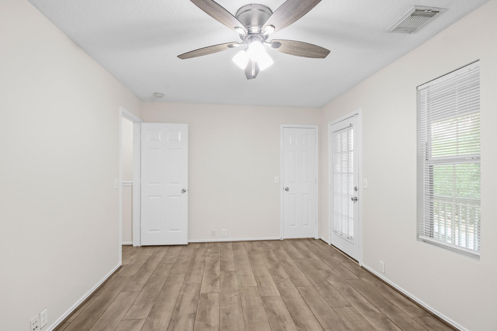 3526 Glenmore Meadow Drive Spring, TX 77386 - Photo 18 of 23 wooden floor in an empty room with a window