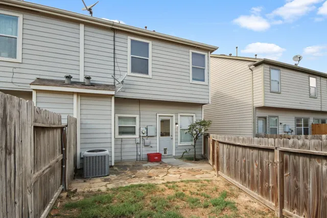 a view of a house with a patio and backyard
