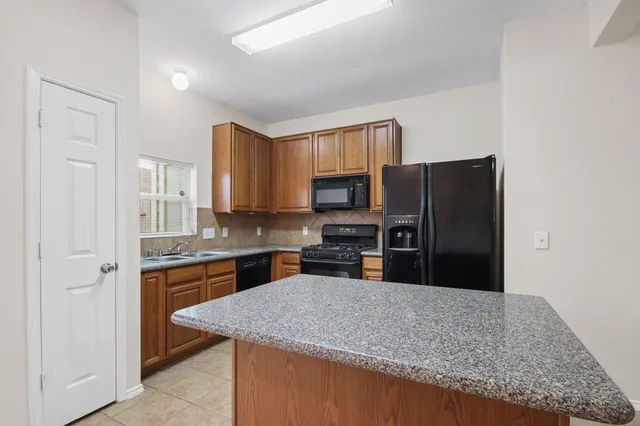 a kitchen with a sink cabinets and wooden floor