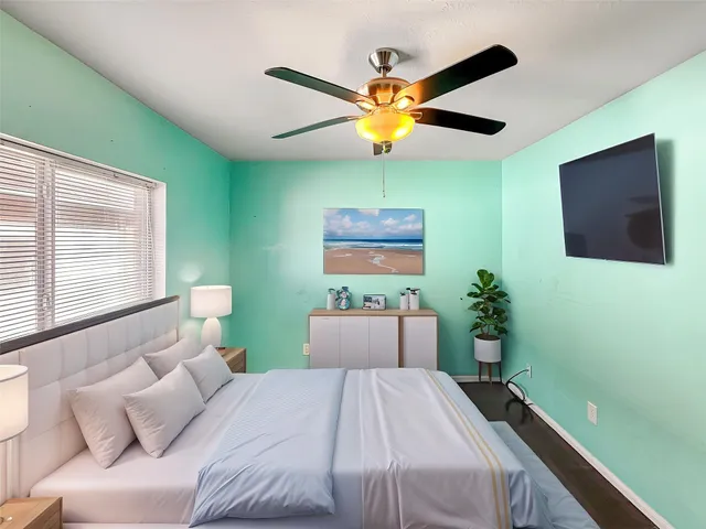 a bedroom with a bed and a flat screen tv