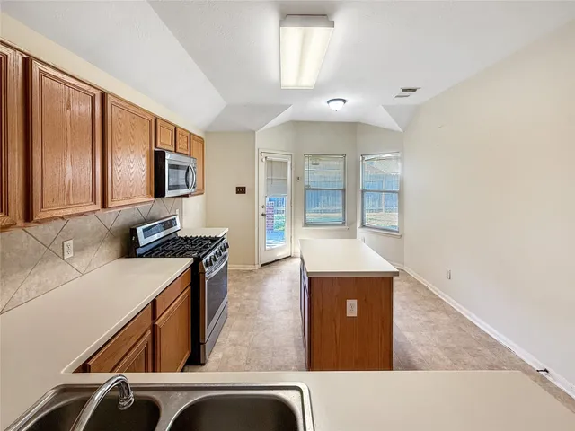 a large kitchen with a large stove top oven