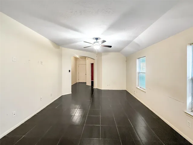a view of a hallway with windows and chandelier