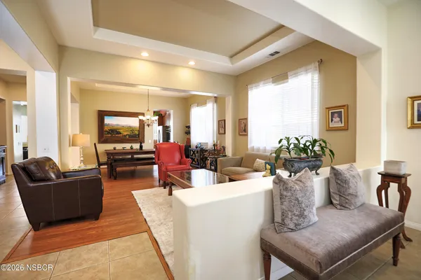 a living room with furniture a fireplace and a large window