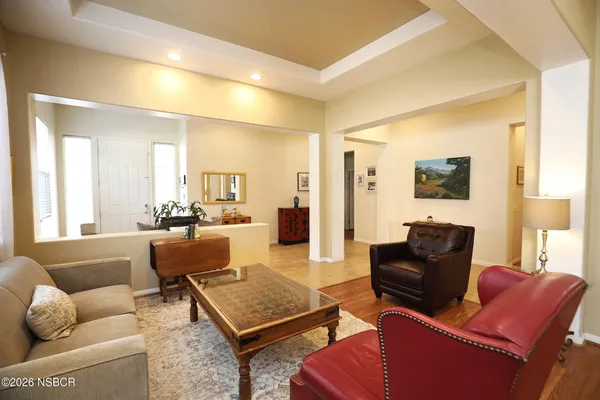 a living room with furniture a flat screen tv and a couch