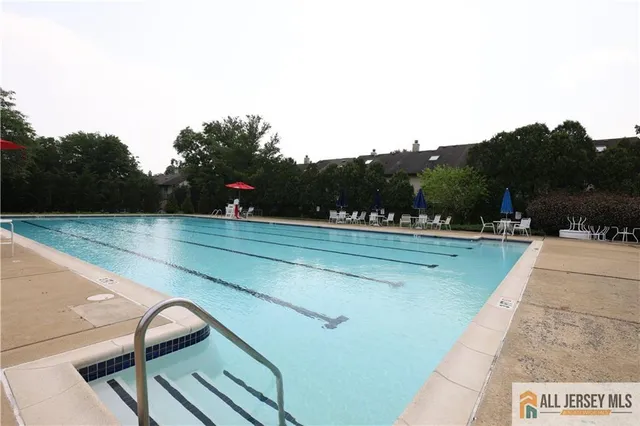 a view of swimming pool is middle in the backyard