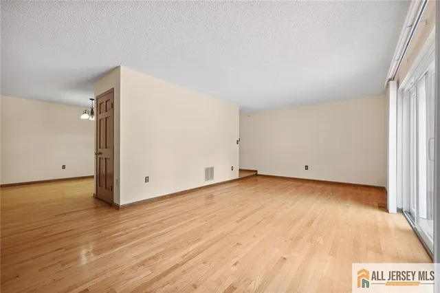 a view of a room with wooden floor