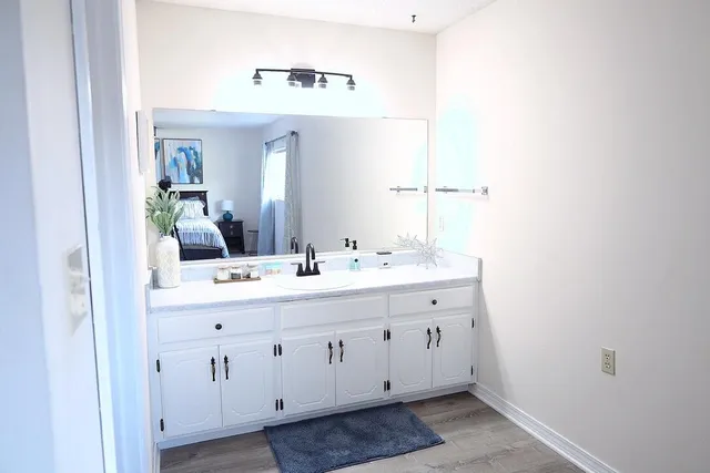 a bathroom with a double vanity sink and mirror
