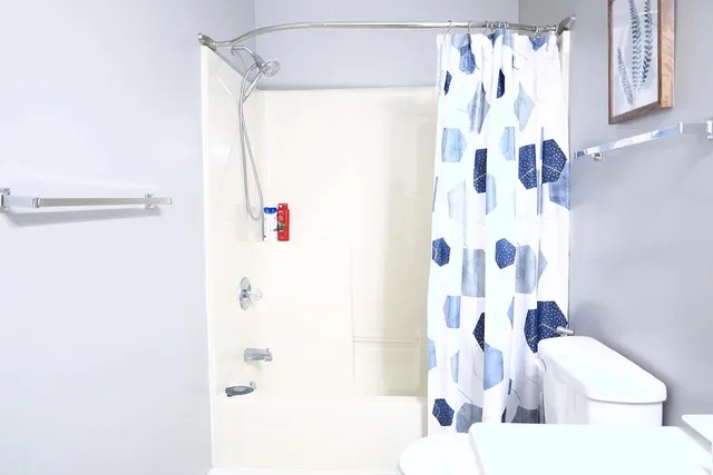 a bathroom with a bathtub and shower