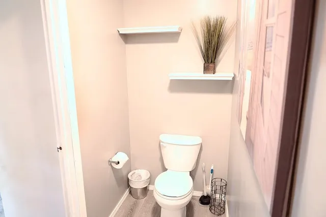a white toilet sitting next to a bathroom sink