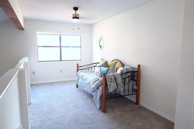 a bed room with a bed and a window