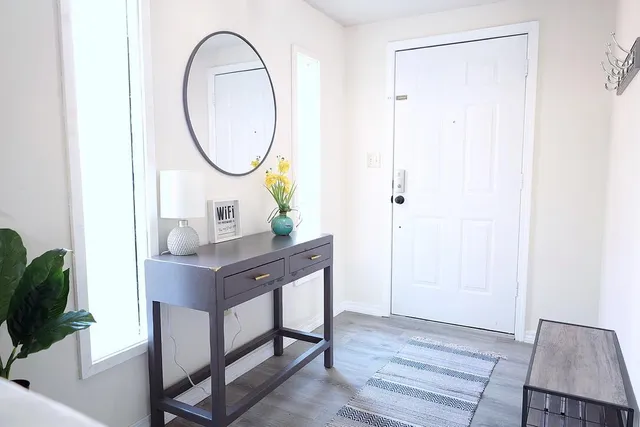 a room with a table and a mirror