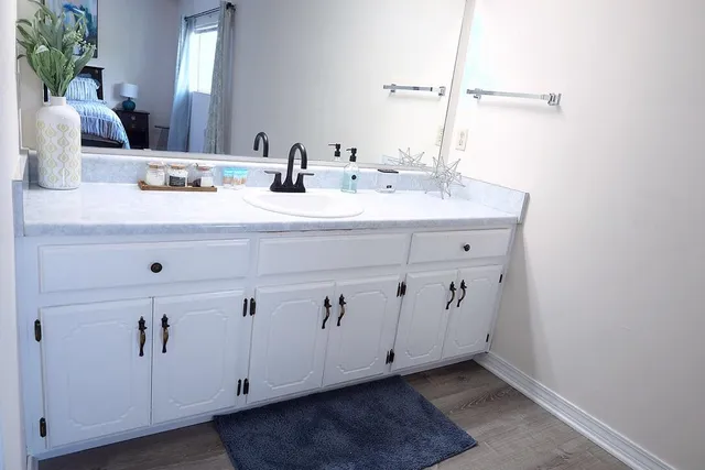 a bathroom with a double vanity sink and a mirror
