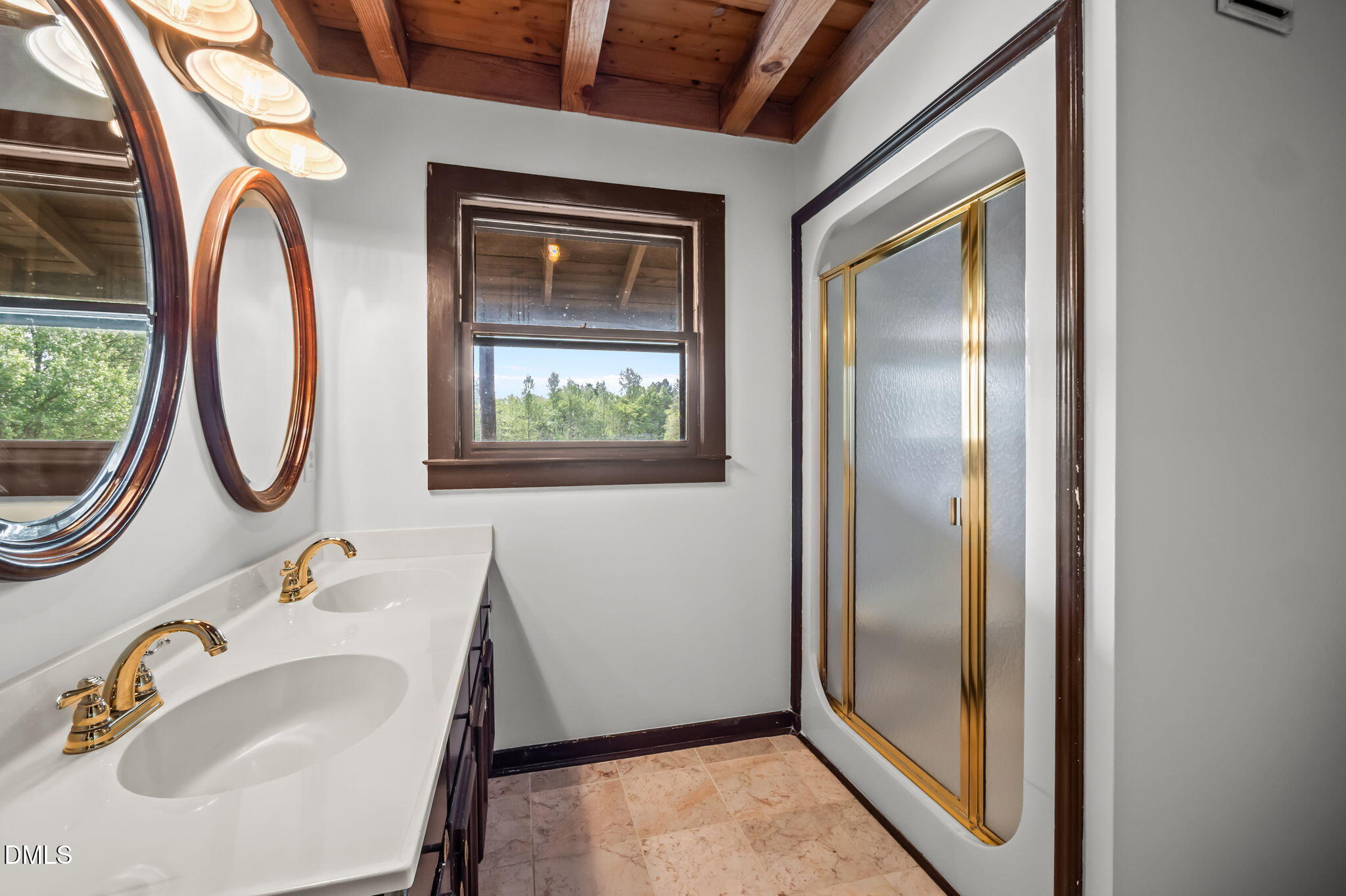 643 Old Stonehouse Road Chapel Hill, NC 27516 - Photo 29 of 63 a bathroom with a sink a mirror and a window