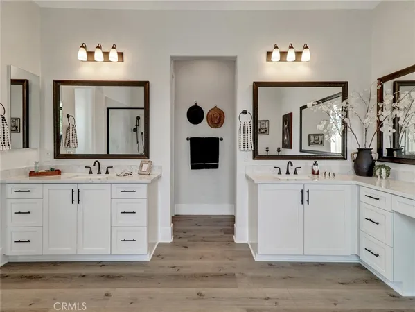 a bathroom with double vanity sink and a mirror