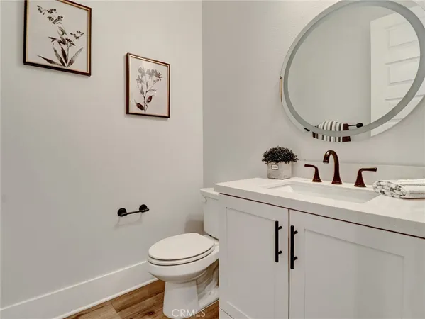 a bathroom with a sink mirror and toilet