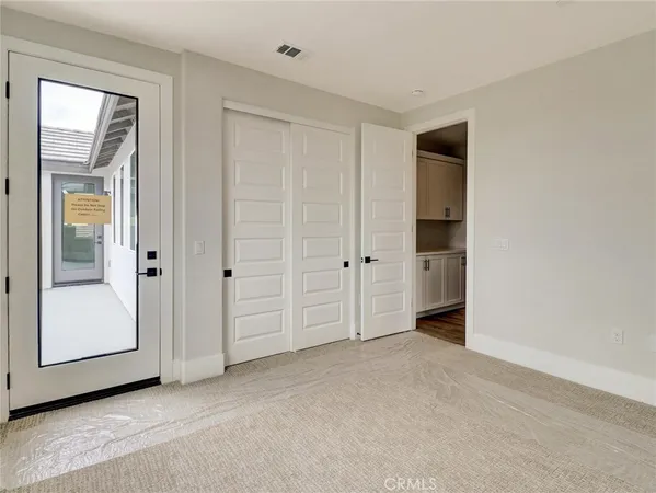 an empty room with a bathroom and a sink
