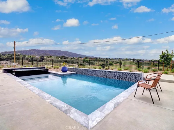 a view of swimming pool with outdoor seating
