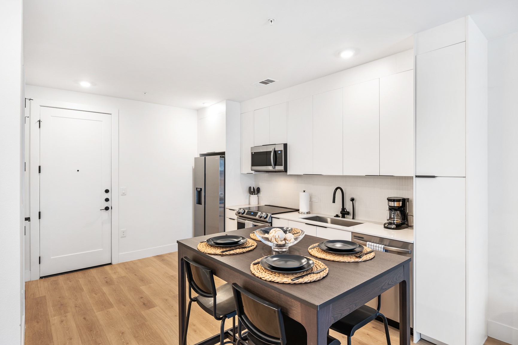 1701 Simond Avenue, Unit 201 Austin, TX 78723 - Photo 7 of 20 a kitchen with a sink a stove and chairs
