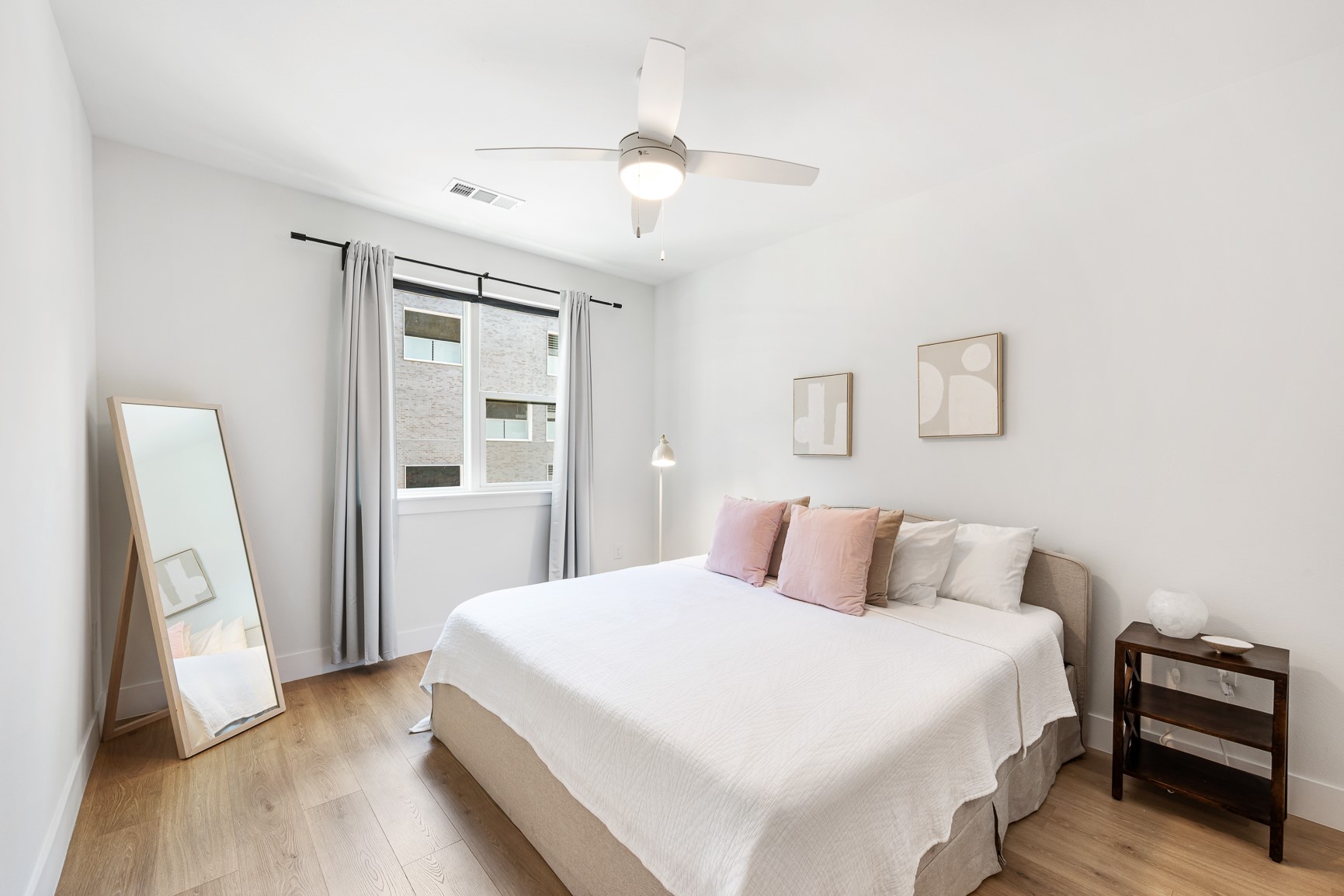 1701 Simond Avenue, Unit 201 Austin, TX 78723 - Photo 8 of 20 a bedroom with a bed and a mirror