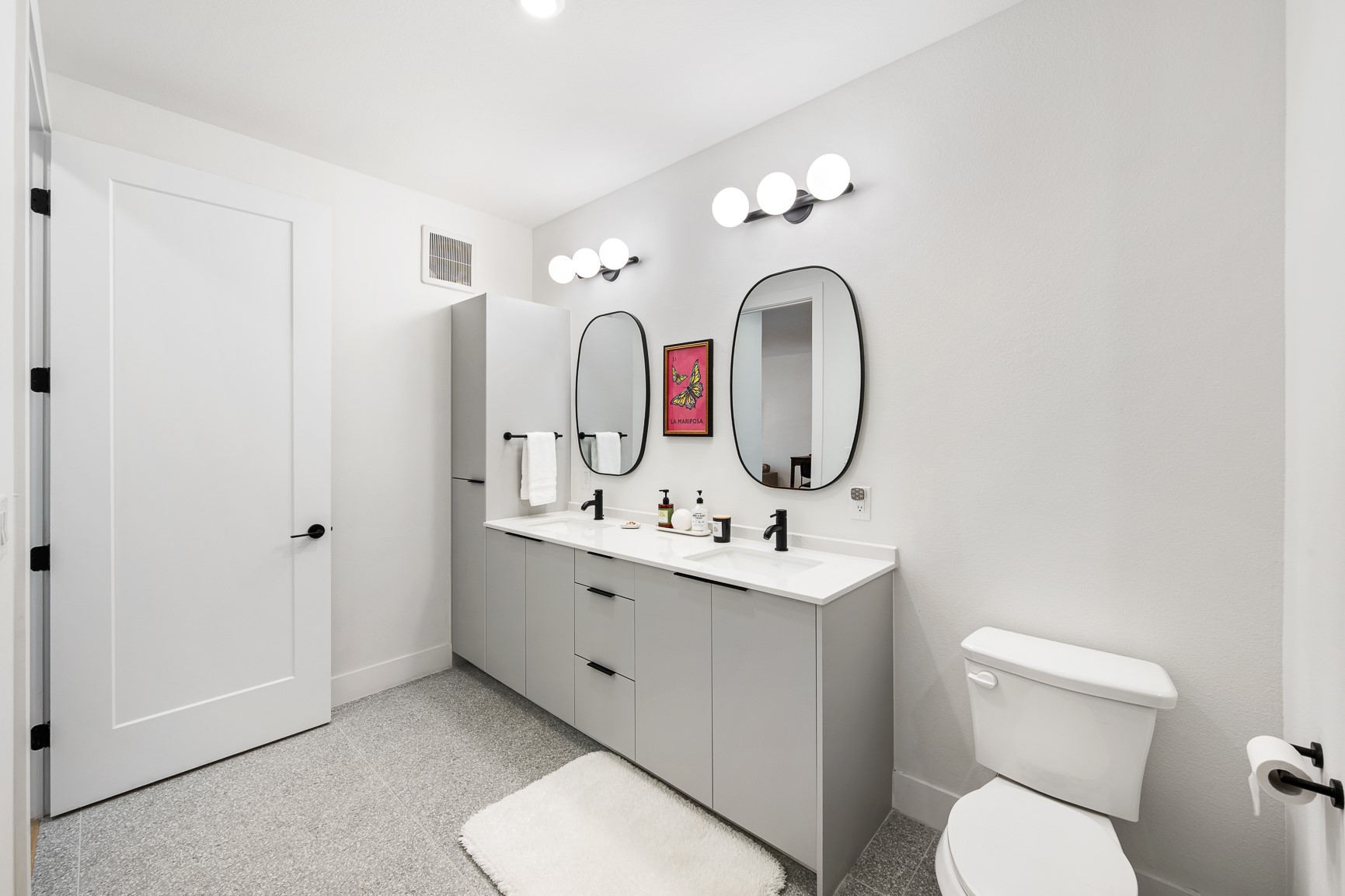 1701 Simond Avenue, Unit 201 Austin, TX 78723 - Photo 10 of 20 a bathroom with a toilet sink and mirror