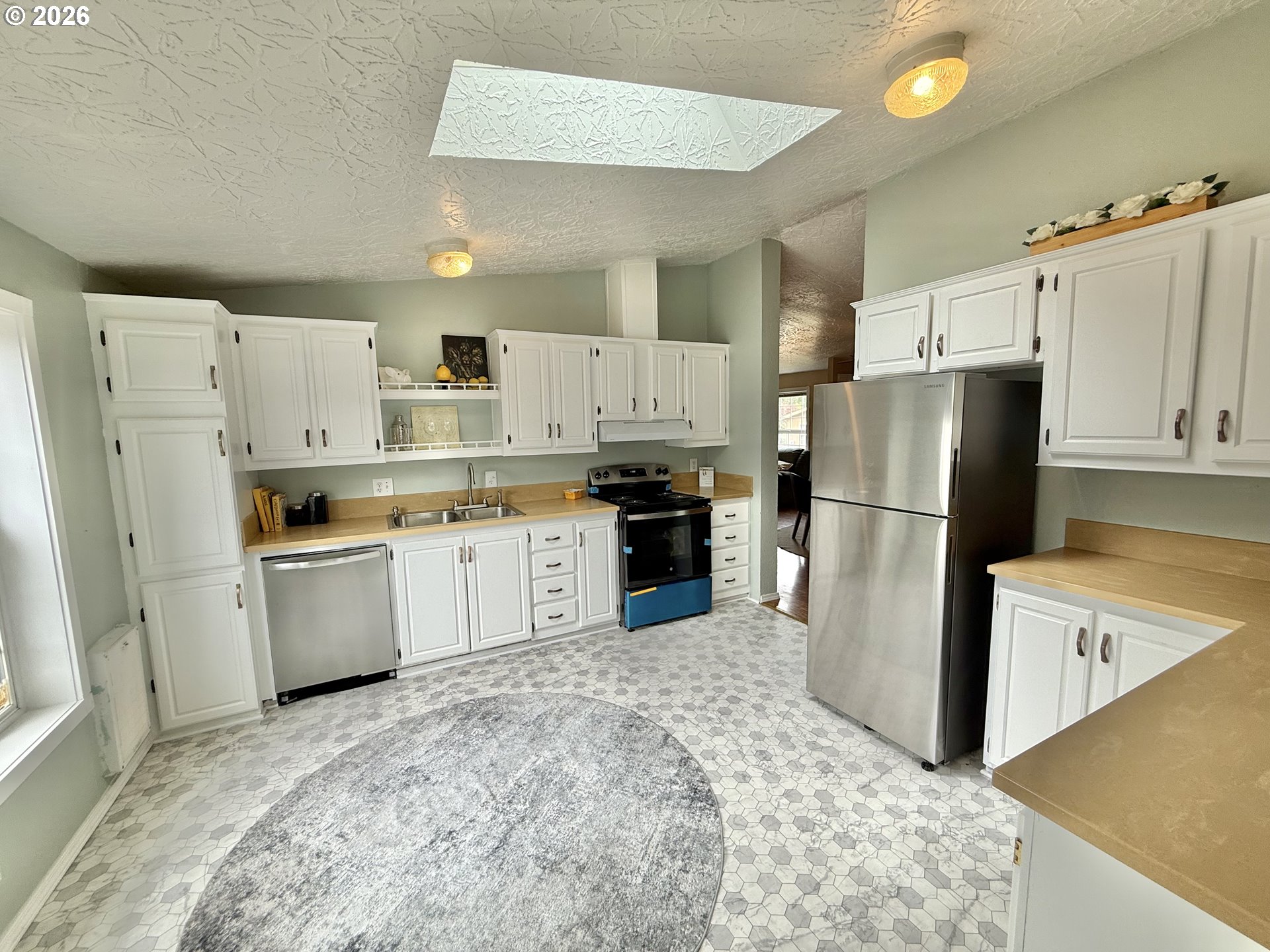 1282 3rd Street, Unit 37 Lafayette, OR 97127 - Photo 6 of 28 a kitchen with white cabinets and white appliances