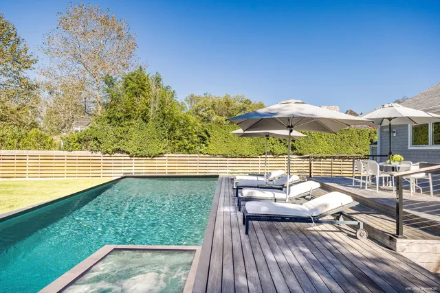 swimming pool view with a seating space