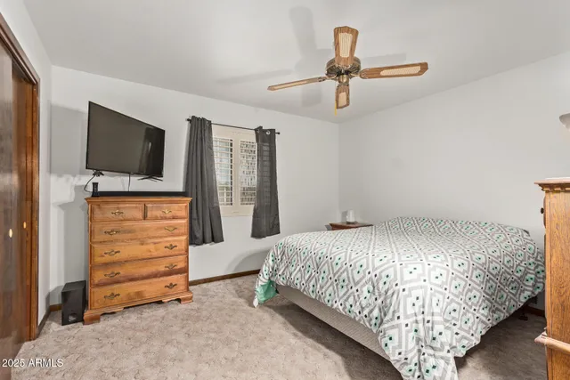 a bathroom with a granite countertop sink toilet mirror and shower